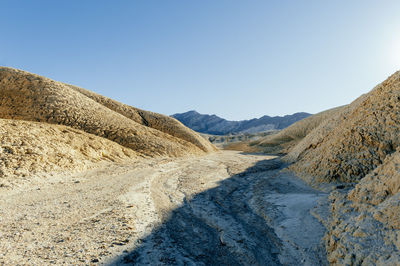 Scenic view of mountains against clear blue sky