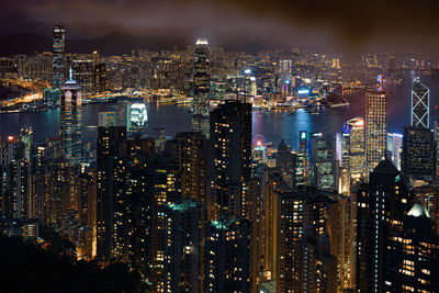 High angle view of illuminated buildings against sky at night