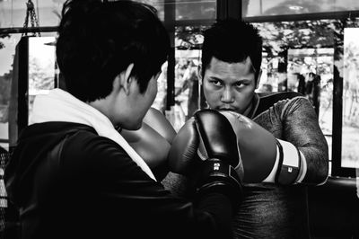 Man and woman boxing in gym