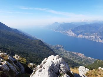 High angle view of lake and mountains against sky