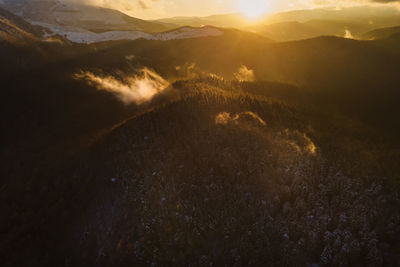 Aerial view of mountain range against sky during sunset