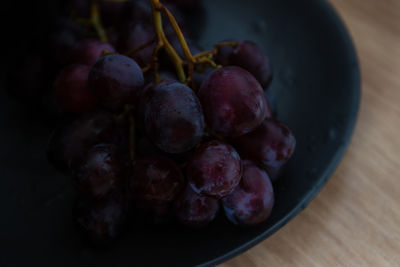 High angle view of grapes in bowl on table