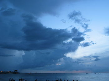 Scenic view of sea against storm clouds