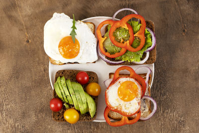 Healthy breakfast with various of sandwiches and toasts on the white plate. top view.