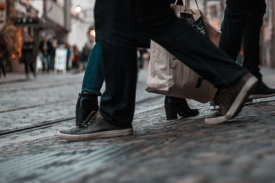 Low section of man walking on street