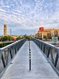 View of bridge and buildings against sky