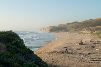 Scenic view of beach against clear sky