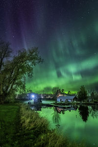 Scenic view of lake against sky at night