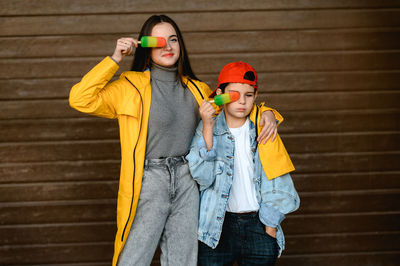 Portrait of woman standing against wall