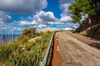 Road by sea against sky