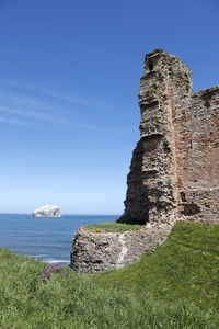 Stone wall with sea in background