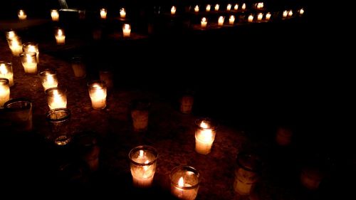 Close-up of illuminated candles in temple