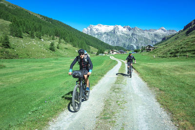 People riding bicycle on mountain road