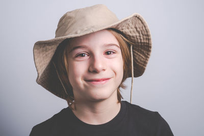 Portrait of smiling boy against white background