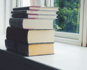 Stack of books on window sill