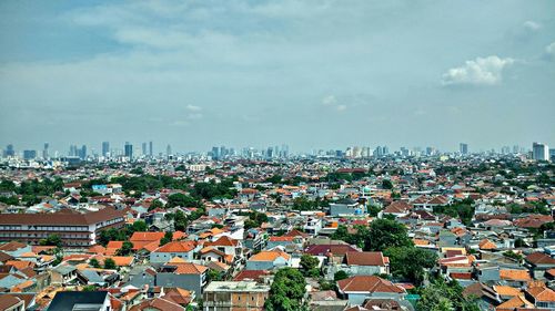 View of cityscape against blue sky