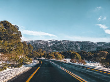 Road by mountain against sky, taken on alpine road near thredbo