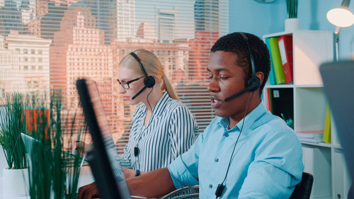 Portrait of man using mobile phone in office