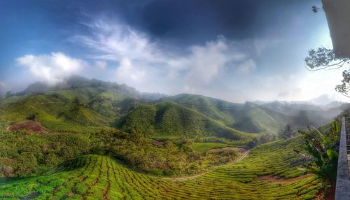 Scenic view of mountains against cloudy sky