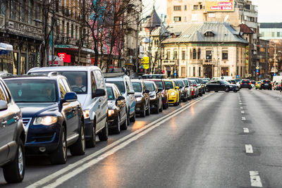 Cars on street amidst buildings in city