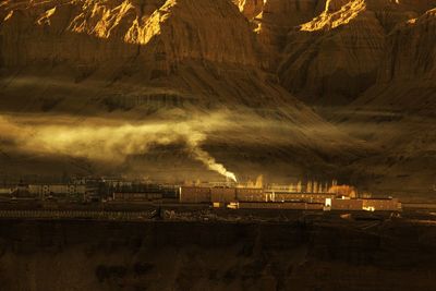 Panoramic view of factory against sky at night