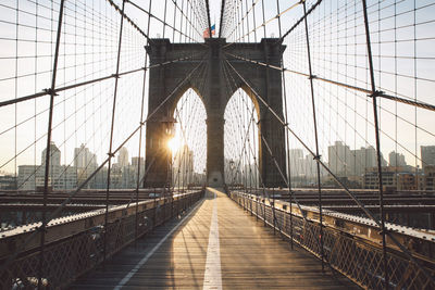 Low angle view of brooklyn bridge in city against sky