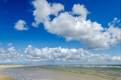 Large beach with blue sky and clouds