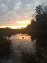 Scenic view of lake at sunset