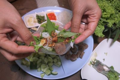 Midsection of person holding salad