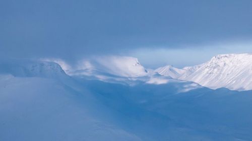 Scenic view of snow mountains against sky