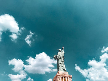 Low angle view of statue against cloudy sky.