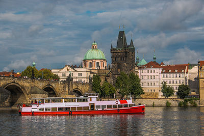 Bridge over river against buildings