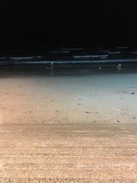 Close-up of beach against sky at night