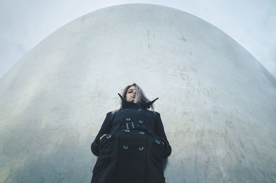 Portrait of woman standing against sky