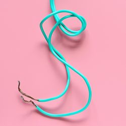 Close-up of cable over pink background