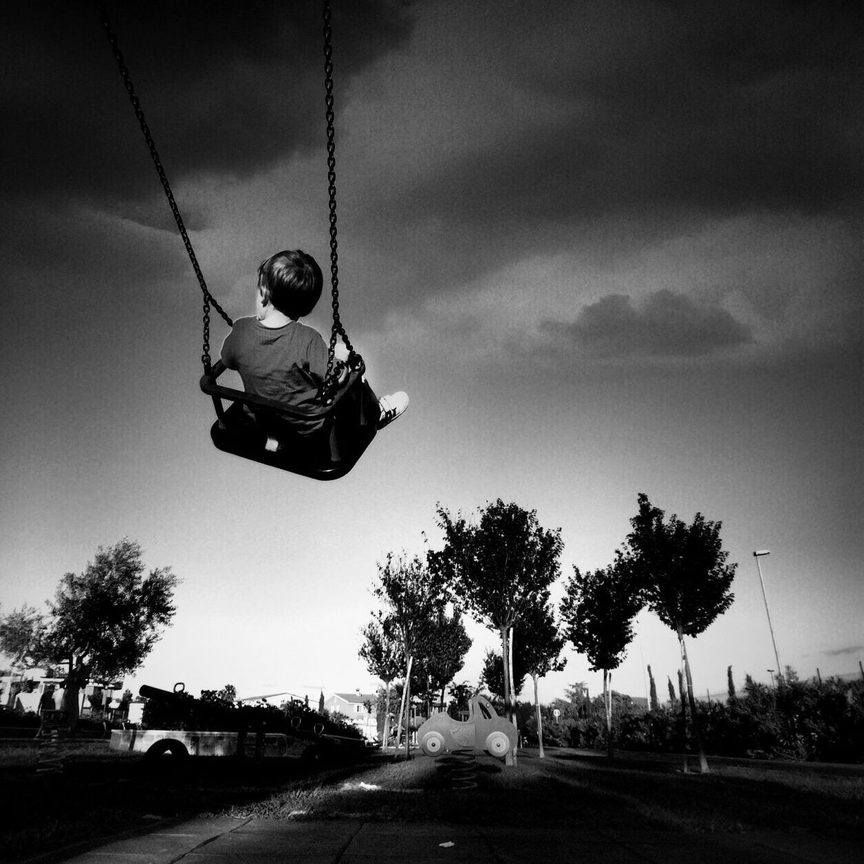 transportation, sky, full length, leisure activity, lifestyles, mode of transport, cloud - sky, tree, land vehicle, sport, mid-air, men, cloudy, childhood, road, riding, bicycle, on the move