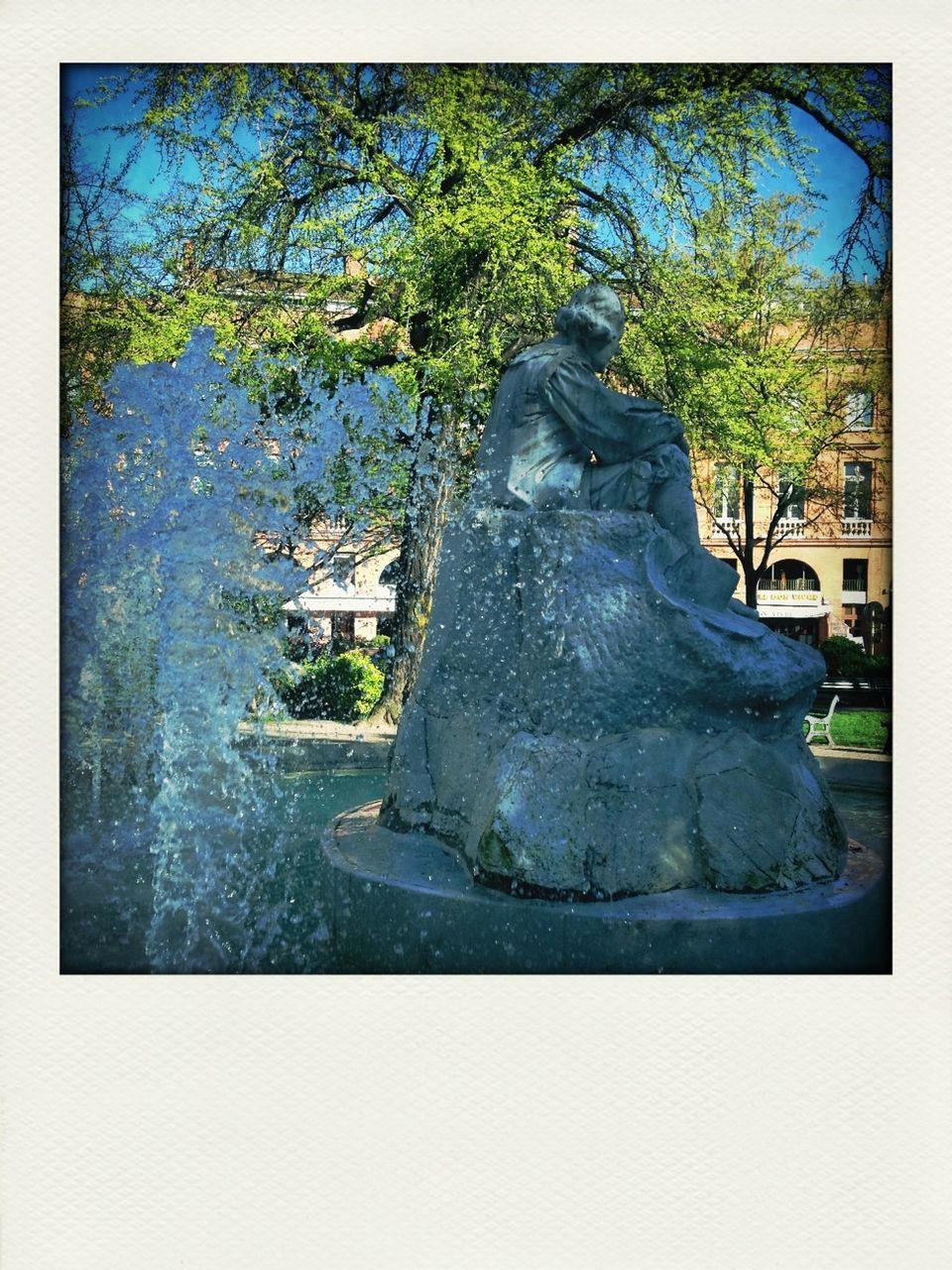 statue, sculpture, building exterior, transfer print, human representation, tree, built structure, architecture, art and craft, art, auto post production filter, creativity, fountain, clear sky, day, religion, outdoors, no people, sunlight