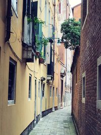 Narrow street amidst buildings in city