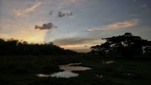 Scenic view of lake against sky at sunset