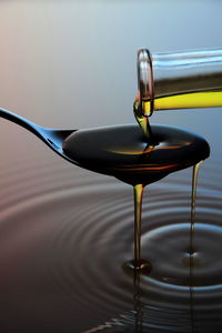 Close-up of oil pouring in spoon