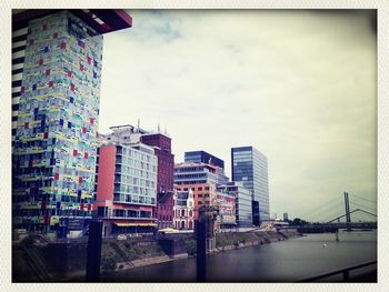 View of buildings against cloudy sky