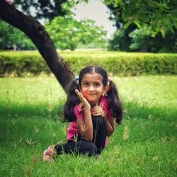 Portrait of a girl posing on green grass and green background