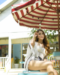 Portrait of young woman sitting outdoors