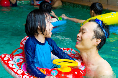 Father and daughter in swimming pool