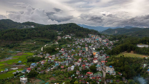 High angle view of townscape and mountains against sky