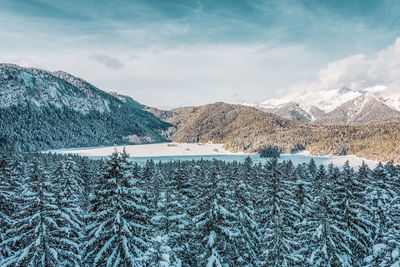 Snowy mountains and trees in the alps. view of the lake eibsee. germany.