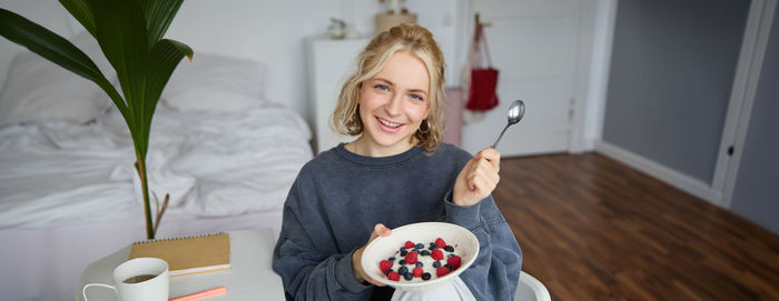 Portrait of young woman using mobile phone