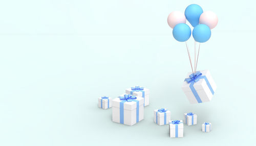 Close-up of multi colored balloons against white background