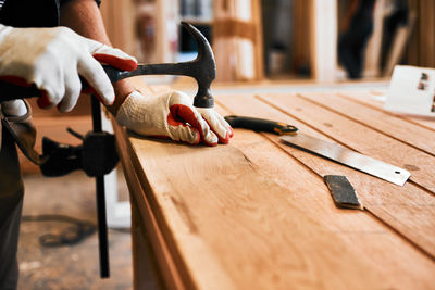 Cropped hand of man working on wood