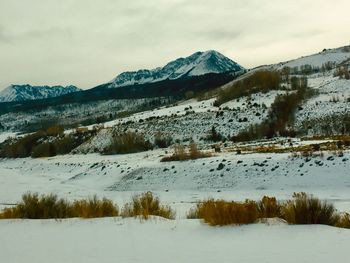 Scenic view of snow covered mountains against sky